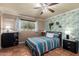 Bright bedroom with a ceiling fan, tile floors, and large window allowing natural light at 4804 S Elm St, Tempe, AZ 85282