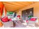 Relaxing covered patio with comfortable seating, tile flooring, and privacy curtains for outdoor enjoyment at 4804 S Elm St, Tempe, AZ 85282