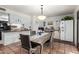 Charming dining room featuring a brick accent wall, modern lighting, and seating for four at 4804 S Elm St, Tempe, AZ 85282