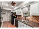 Well-lit kitchen with stainless steel sink, mosaic backsplash, and plenty of cabinet space at 4804 S Elm St, Tempe, AZ 85282
