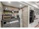 Cozy kitchen nook with rustic wood paneling, open shelving, and modern appliances at 4804 S Elm St, Tempe, AZ 85282