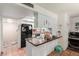 Well-lit kitchen featuring granite countertops and an eat-in bar area at 4804 S Elm St, Tempe, AZ 85282