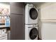 Modern laundry area with stacked washer and dryer and cabinetry for storage solutions at 4804 S Elm St, Tempe, AZ 85282
