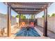Inviting backyard patio with pergola, fire pit, and comfortable seating, creating an ideal outdoor retreat at 4804 S Elm St, Tempe, AZ 85282