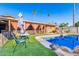Outdoor pool area with a covered patio, artificial turf, and desert landscaping perfect for relaxing at 4804 S Elm St, Tempe, AZ 85282