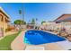 Backyard pool surrounded by lush landscaping and patio furniture, perfect for outdoor relaxation at 4804 S Elm St, Tempe, AZ 85282