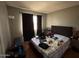 Bedroom with dark curtains, a bed with patterned bedding, and a lamp at 5002 N 41St Ave, Phoenix, AZ 85019
