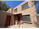 Two story townhome with red door and window coverings at 5002 N 41St Ave, Phoenix, AZ 85019