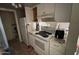 Modest kitchen with white appliances and cabinetry, offering essential functionality at 5002 N 41St Ave, Phoenix, AZ 85019