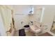 Bright bathroom with pink sink, shower with curtain and tile flooring at 650 N 65Th Way, Mesa, AZ 85205