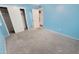View of bedroom with closet and neutral carpet and blue walls at 650 N 65Th Way, Mesa, AZ 85205