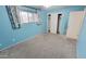 Bedroom featuring light blue walls, plush carpeting, and ample natural light at 650 N 65Th Way, Mesa, AZ 85205