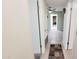 Hallway with tile flooring, storage closet, and views into other rooms at 650 N 65Th Way, Mesa, AZ 85205