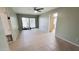 Spacious living room with tiled flooring, green walls, sliding glass door and ceiling fan at 650 N 65Th Way, Mesa, AZ 85205