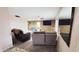 A comfortable living room featuring large windows, ceiling fan and an adjacent dining area at 650 N 65Th Way, Mesa, AZ 85205