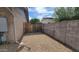 Gated side yard with gravel, offering secure storage or potential for a dog run at 650 N 65Th Way, Mesa, AZ 85205