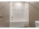 Bright bathroom with white tiled shower and tub combo with silver fixtures and accents at 750 E Northern E Ave # 2145, Phoenix, AZ 85020