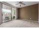 Bedroom with sliding glass doors leading to a balcony and neutral colored carpet at 750 E Northern E Ave # 2145, Phoenix, AZ 85020
