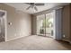 Carpeted bedroom featuring a ceiling fan and sliding glass doors to a balcony at 750 E Northern E Ave # 2145, Phoenix, AZ 85020