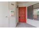 Entrance featuring a red door with a mail slot and a security light above the unit number at 750 E Northern E Ave # 2145, Phoenix, AZ 85020