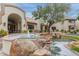 Grand building entrance with stone fountain, lush landscaping, and arched entryway, creating a welcoming ambiance at 750 E Northern E Ave # 2145, Phoenix, AZ 85020