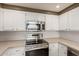 Bright kitchen features white cabinets, stainless steel appliances, and a modern countertop at 750 E Northern E Ave # 2145, Phoenix, AZ 85020