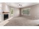 Spacious living room features a neutral palette with carpeted floors, a fireplace, and plenty of natural light at 750 E Northern E Ave # 2145, Phoenix, AZ 85020