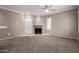 Cozy living room with a fireplace, carpeted floors, a ceiling fan, and natural light at 750 E Northern E Ave # 2145, Phoenix, AZ 85020