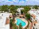 Aerial view of a kidney-shaped community pool with lounge chairs and a covered seating area at 750 E Northern E Ave # 2145, Phoenix, AZ 85020
