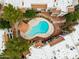 Aerial view of a kidney-shaped pool in a community setting with a covered seating area at 750 E Northern E Ave # 2145, Phoenix, AZ 85020