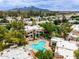An aerial view of a kidney shaped pool with lounge chairs and jacuzzi in a community setting at 750 E Northern E Ave # 2145, Phoenix, AZ 85020