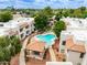 Aerial view of a community pool with a covered area and seating surrounded by buildings at 750 E Northern E Ave # 2145, Phoenix, AZ 85020