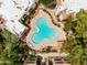 Aerial view of a uniquely-shaped community pool with seating, landscaping, and buildings around at 750 E Northern E Ave # 2145, Phoenix, AZ 85020