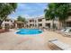 A lovely community swimming pool with lounge chairs and tables outside of the residences on a sunny day at 750 E Northern E Ave # 2145, Phoenix, AZ 85020
