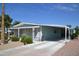 Inviting single-story home featuring a long carport and desert landscaping at 8310 E Deep Canyon Ct, Mesa, AZ 85208