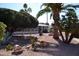 Landscaped yard with mature trees and a charming home nestled in the background at 8310 E Deep Canyon Ct, Mesa, AZ 85208