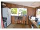 Charming kitchen with wood paneling, bright window and white refrigerator at 8310 E Deep Canyon Ct, Mesa, AZ 85208