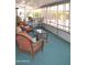 Inviting sun room with wicker furniture and views of the surrounding garden at 8310 E Deep Canyon Ct, Mesa, AZ 85208