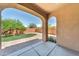 Covered porch overlooks a low-maintenance backyard featuring gravel and a patch of artificial turf at 9302 E Horseshoe Bend Dr, Scottsdale, AZ 85255