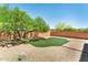 Desert backyard includes rock ground cover, a mature shade tree, and a patch of artificial turf at 9302 E Horseshoe Bend Dr, Scottsdale, AZ 85255
