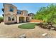 Backyard features a patch of artificial turf surrounded by decorative rocks and a stucco wall at 9302 E Horseshoe Bend Dr, Scottsdale, AZ 85255