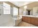 Primary bathroom featuring a separate tub and shower, double sinks, and tile flooring at 9302 E Horseshoe Bend Dr, Scottsdale, AZ 85255