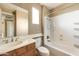 Bathroom featuring a sink, vanity with brown cabinets, toilet, shower and bathtub combination at 9302 E Horseshoe Bend Dr, Scottsdale, AZ 85255