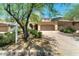Tan two story home featuring a two car garage and desert landscaping at 9302 E Horseshoe Bend Dr, Scottsdale, AZ 85255