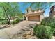 Tan two story home featuring a two car garage and desert landscaping at 9302 E Horseshoe Bend Dr, Scottsdale, AZ 85255