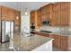 Kitchen with granite countertops, stainless steel appliances and wood cabinets at 9302 E Horseshoe Bend Dr, Scottsdale, AZ 85255