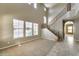 Open living room featuring large windows, high ceilings and a wooden staircase at 9302 E Horseshoe Bend Dr, Scottsdale, AZ 85255