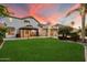 Expansive backyard with covered patio, gazebo, and well-manicured lawn with mature landscaping at 1001 N Peppertree Dr, Gilbert, AZ 85234