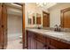 Bathroom features a double vanity with granite countertop and stylish fixtures and adjoins the toilet and bathtub at 1001 N Peppertree Dr, Gilbert, AZ 85234