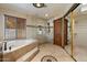Luxurious bathroom with a glass enclosed shower, soaker tub, and decorative tile accents at 1001 N Peppertree Dr, Gilbert, AZ 85234
